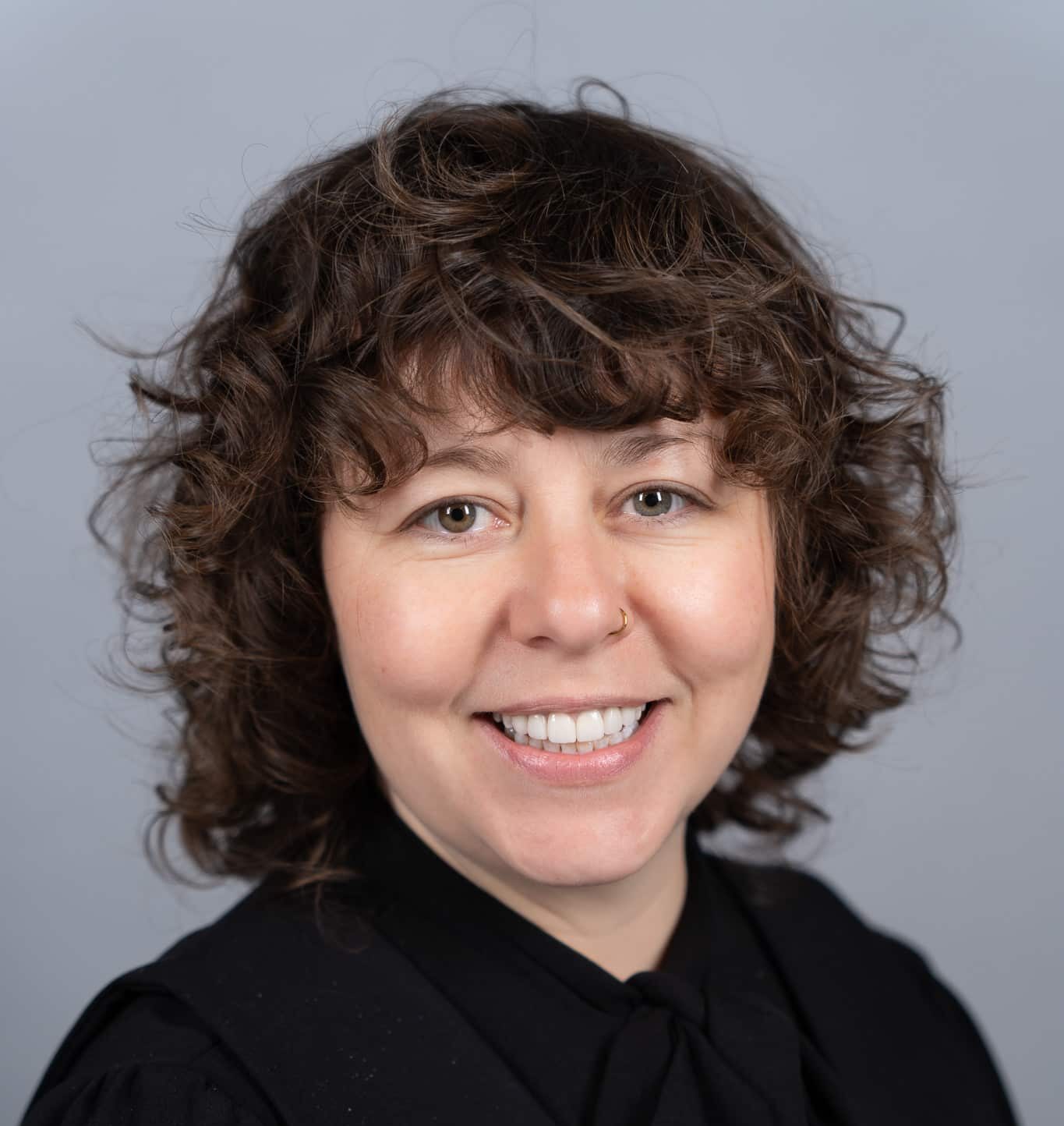 Elizabeth Wimbush - smiling woman with curly brown hair