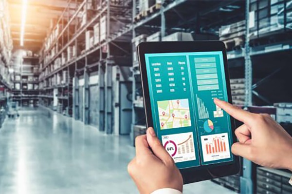 Warehouse management innovative software in computer for real time monitoring of goods package delivery . Computer screen showing smart inventory dashboard for storage and supply chain distribution .