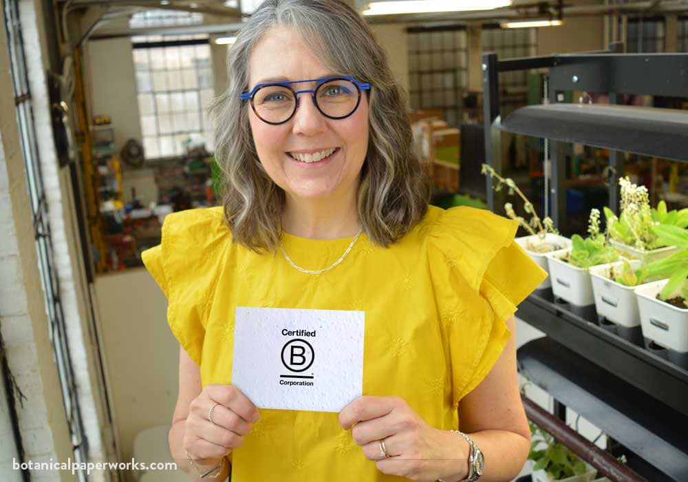 Heidi Reimer-Epp holding a B Corp certified sign