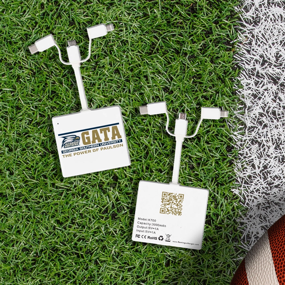 two small square chargers with 3 ports each on football grass - one with GATA logo, one with a QR code