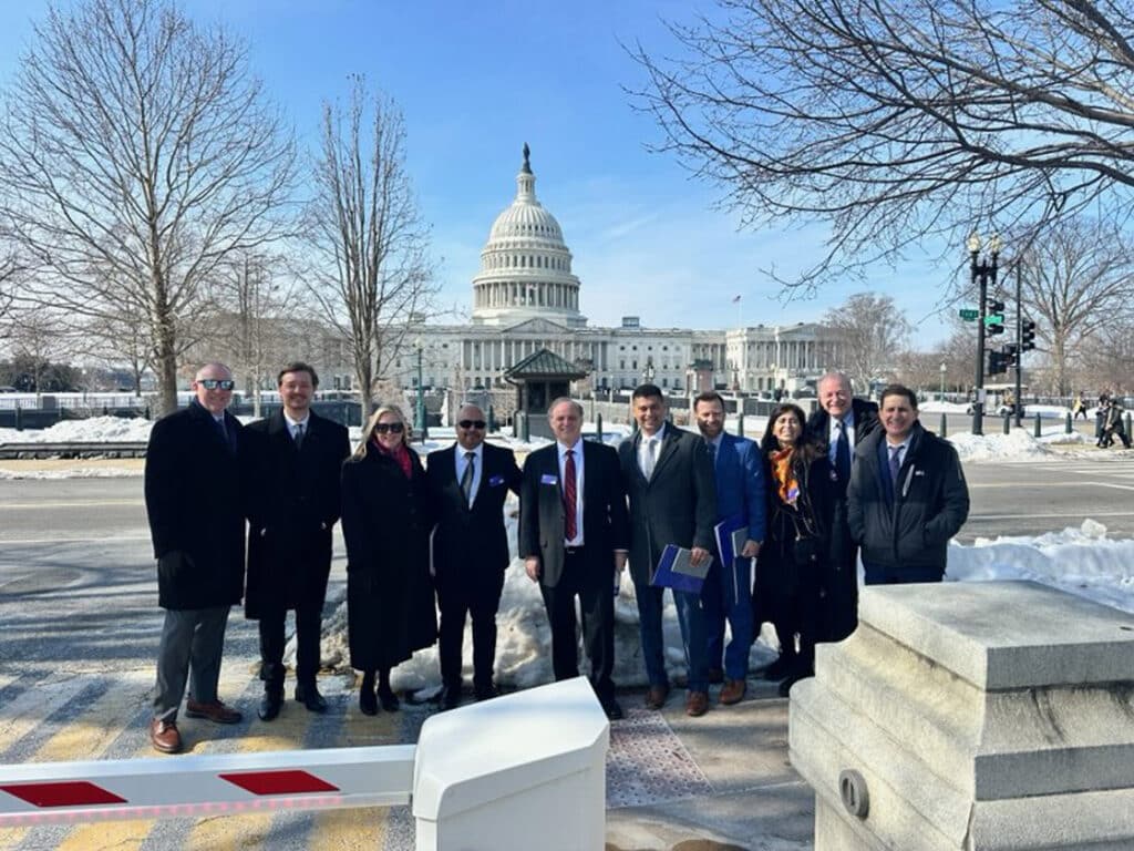 a dozen business people in front of the US Capitol